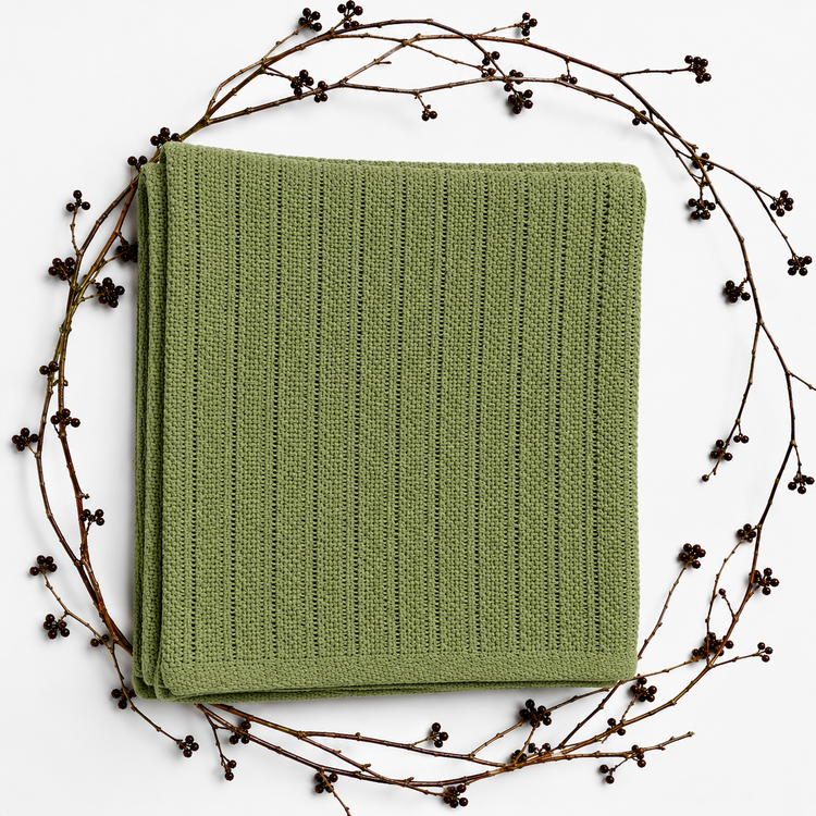 Folded sage green baby blanket with narrow vertical textured stripes and a plain border.