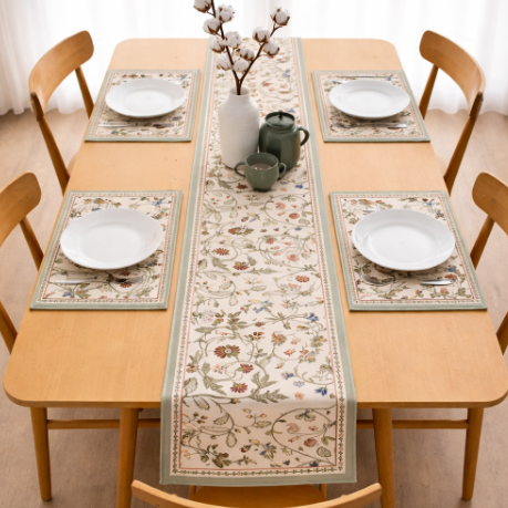 Cream table runner with delicate colourful floral vines and matching placemats.