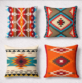 Four colourful cushion covers with rust, teal and cream geometric diamond patterns.