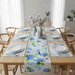 Cream bird-and-blue-flower table runner with matching placemats.