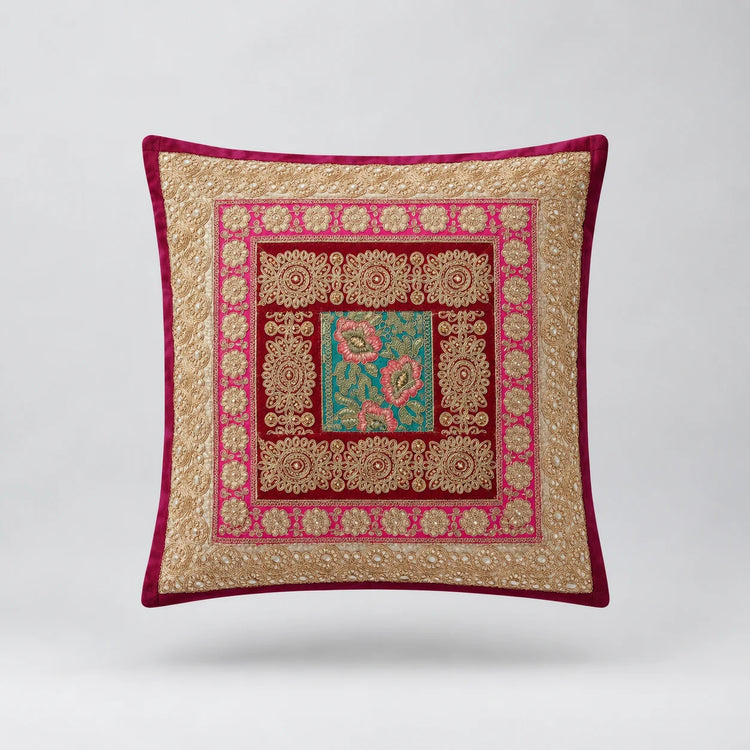 Burgundy-bordered cushion cover with layered pale gold coloured and red frames around a teal floral centre.