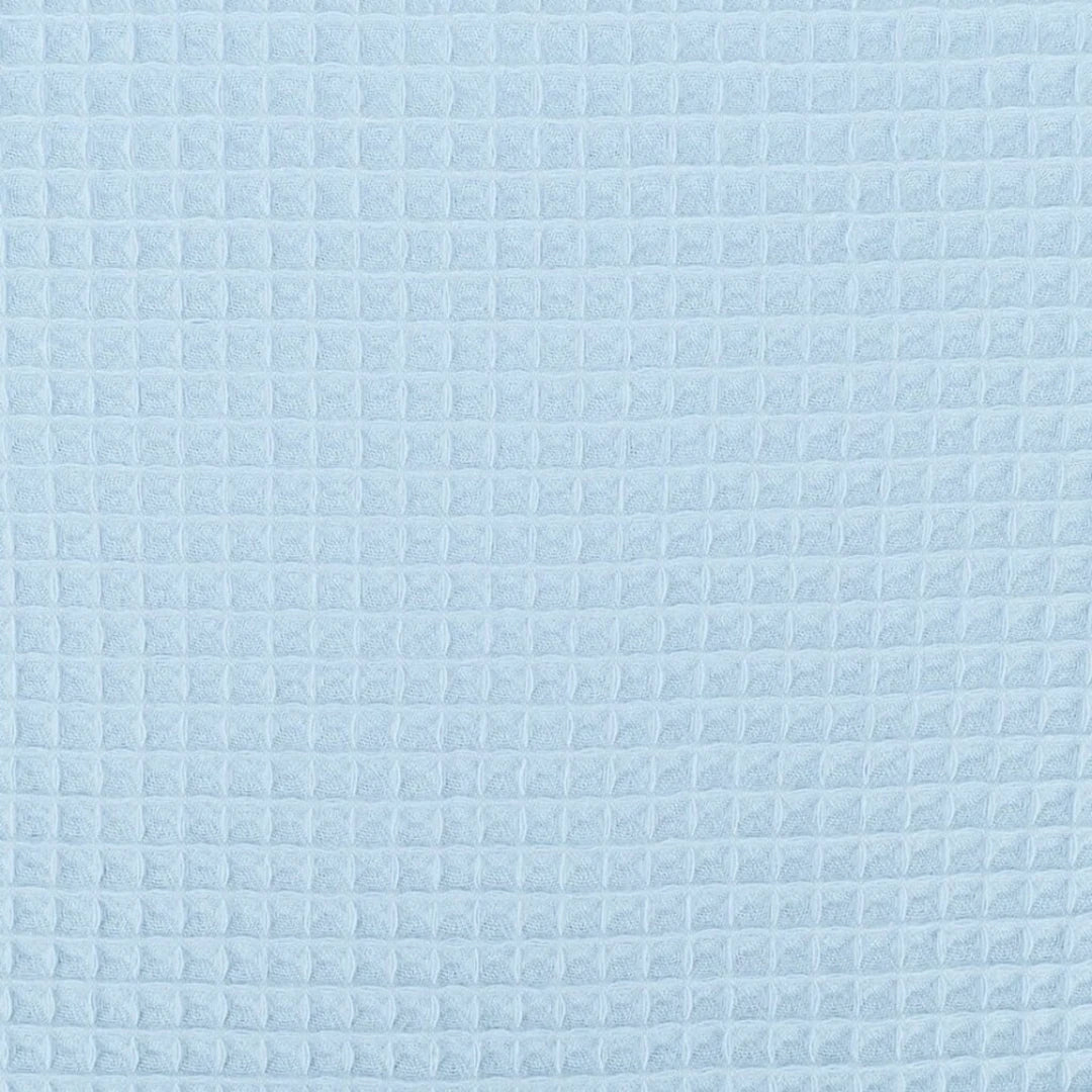 A close-up of a light blue textured fabric with a repeating waffle or embossed grid pattern.