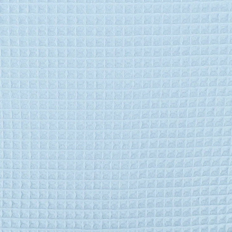 Close-up of the light blue grid texture of a cotton thermal blanket.