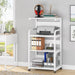 White rolling shelf holding a printer, headphones, binders and office supplies