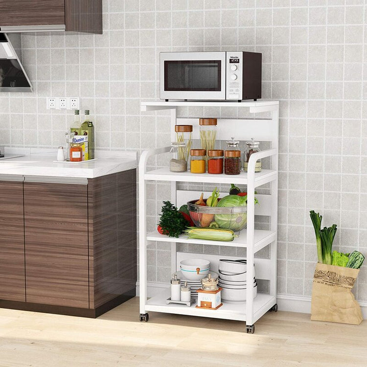 White rolling kitchen rack holding a microwave, condiments and produce