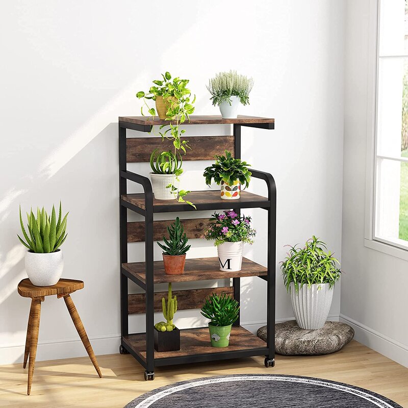 Brown shelving cart displaying potted plants beside a window