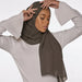 Model wearing a plain taupe chiffon stole as a headscarf.