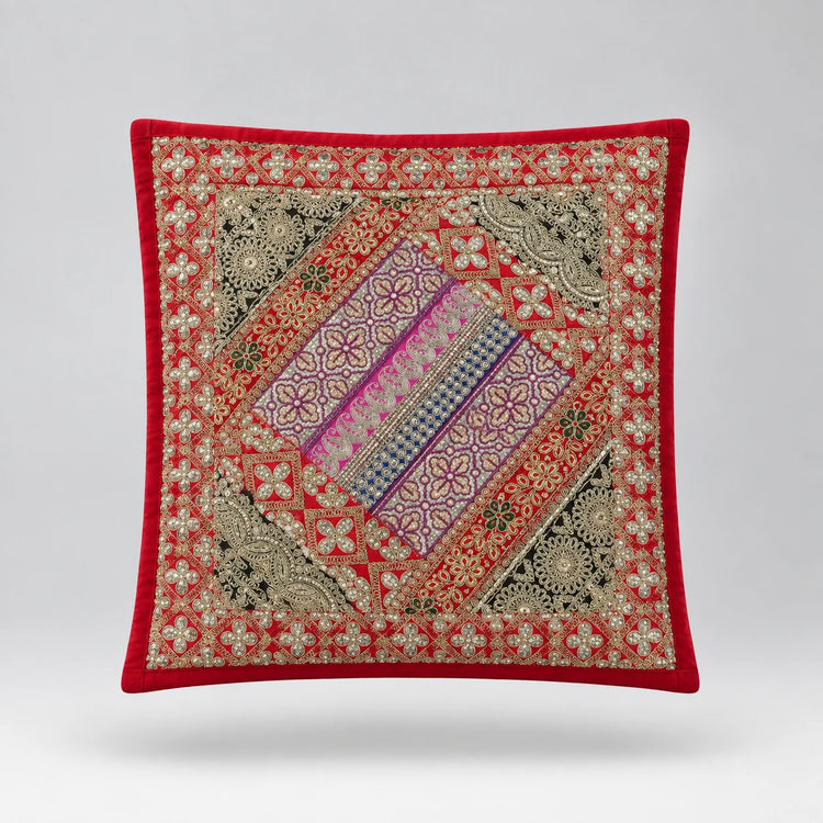 Red-bordered cushion cover with a green floral field and a diagonal purple ornamental panel.