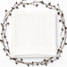 White ribbed blanket displayed flat inside a circle of decorative dried branches.