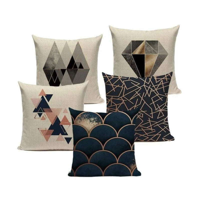 Five cushion covers with dark blue, bronze and cream geometric designs.