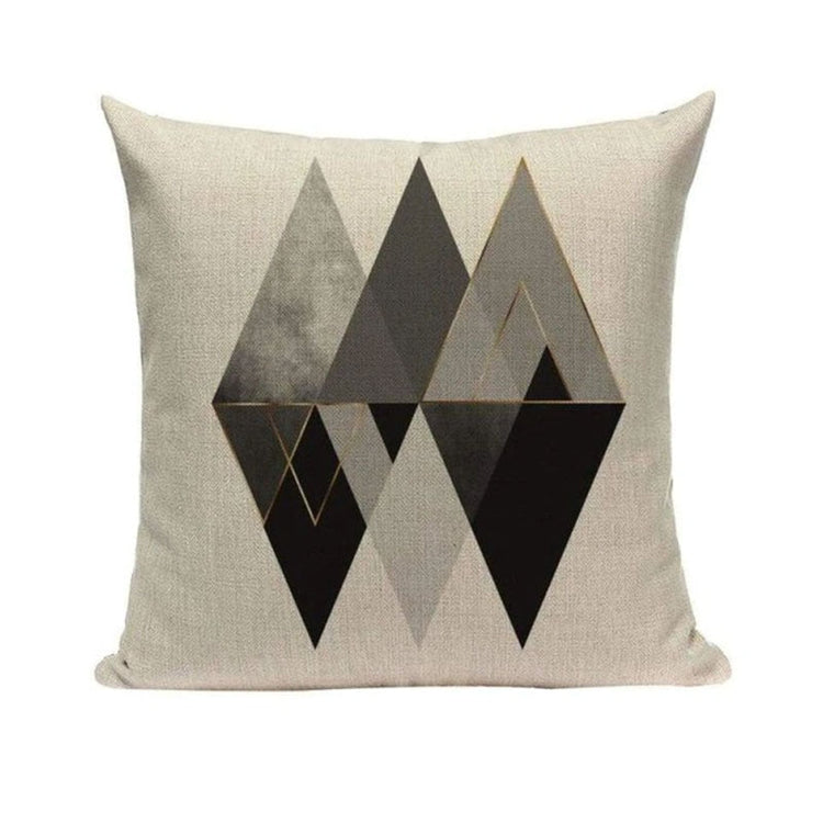 Cream cushion cover with overlapping black and grey triangular shapes.