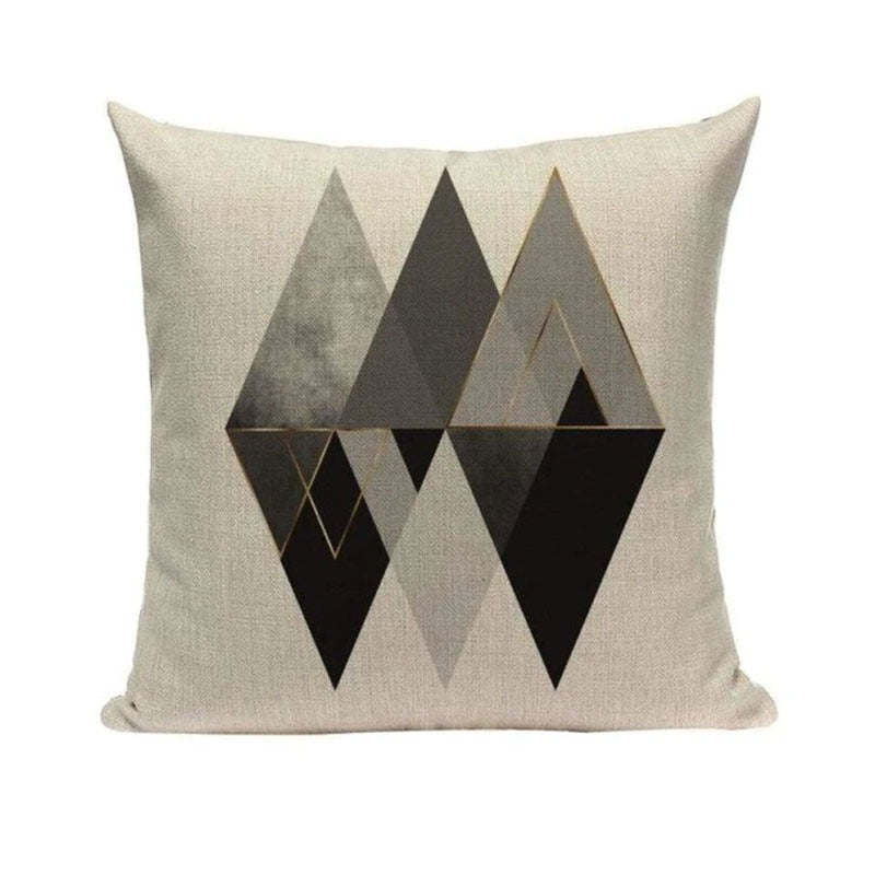 Cream cushion cover with overlapping black and grey triangular shapes.