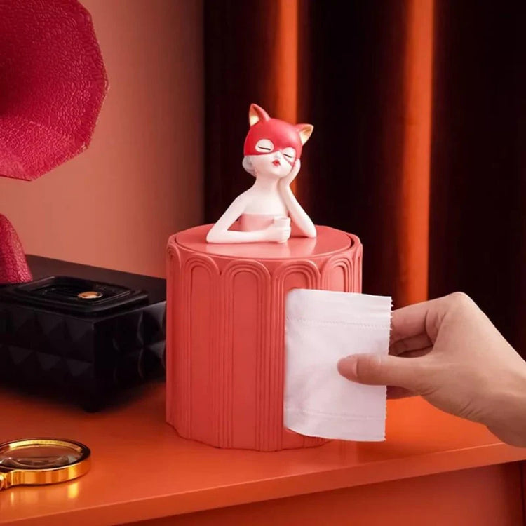 Tissue being pulled from a coral figurine-topped dispenser.