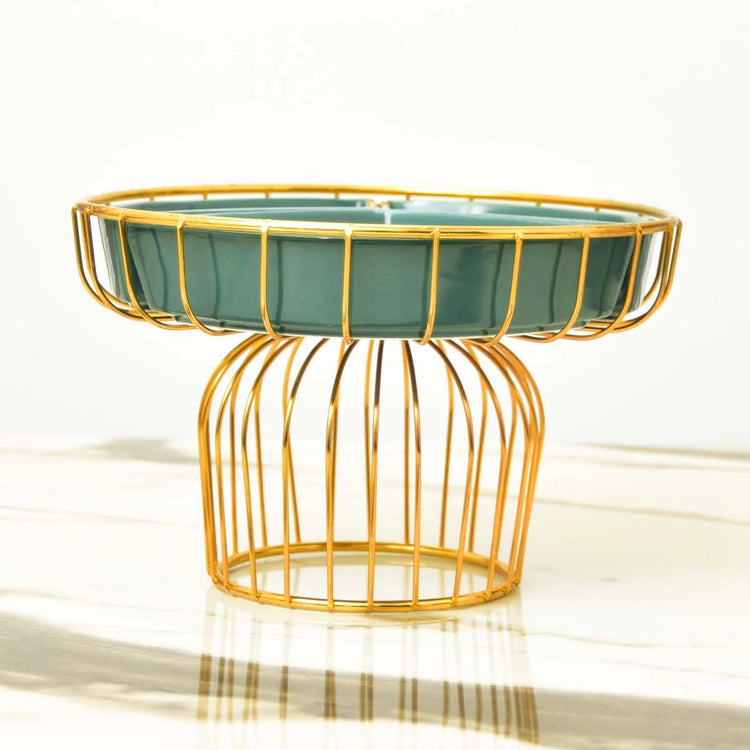 Side view of a green snack tray on a gold-coloured wire pedestal.