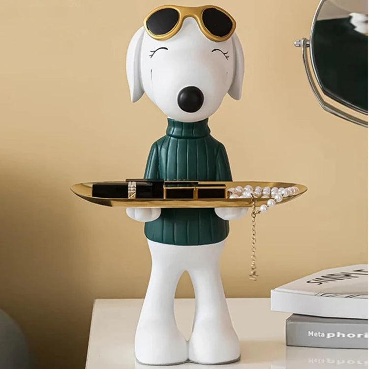 White dog figurine in a green top holding a round gold-coloured tray.