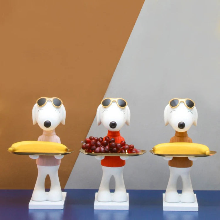 Three cartoon dog figurines wearing sunglasses and holding serving trays.