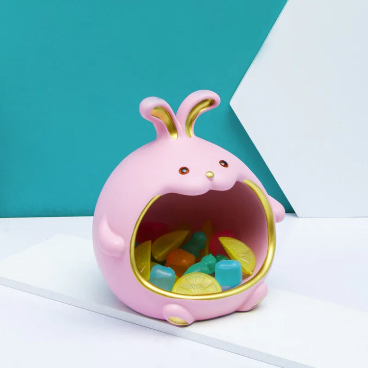 Close view of a pink rabbit-shaped organizer holding small colourful objects.