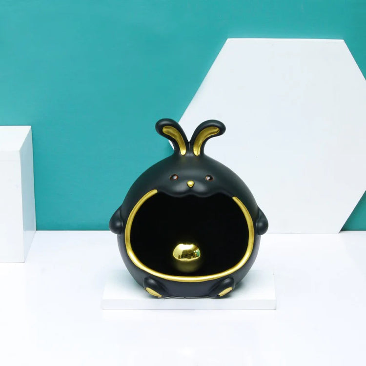 Black rabbit-shaped organizer with gold-coloured details.