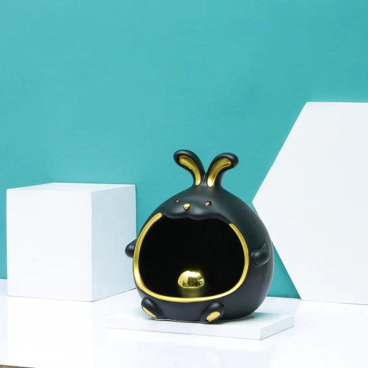 Black rabbit-shaped organizer displayed against a turquoise background.