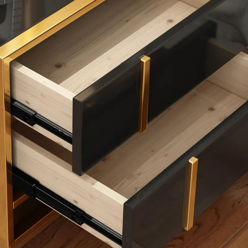 Close-up of two open black bedside cabinet drawers with gold-colored handles.