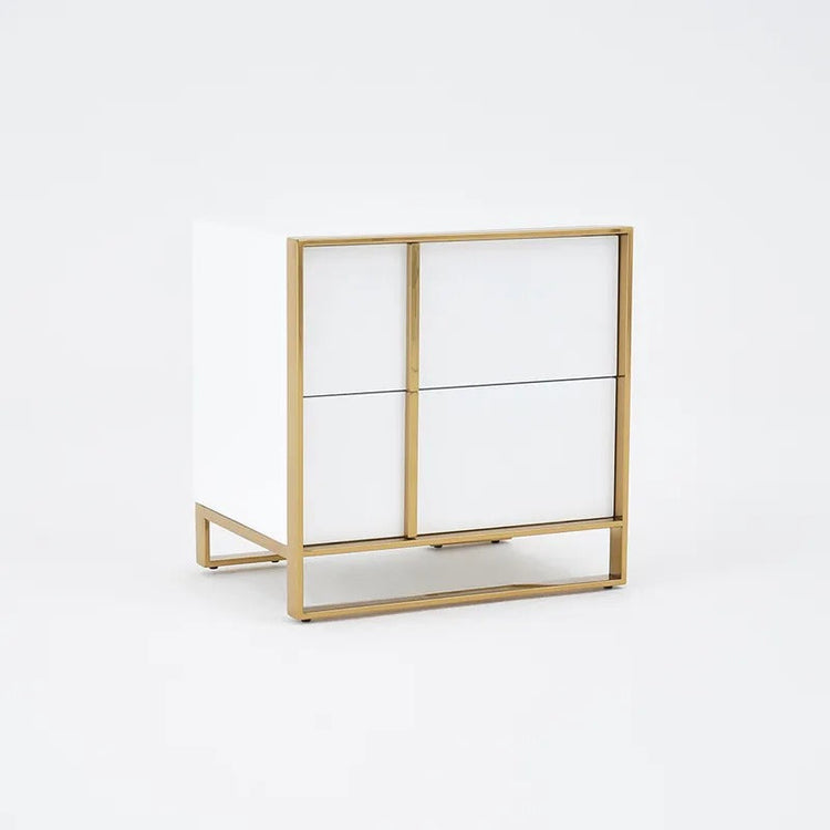 Angled front view of a white bedside cabinet with gold-colored outline frame and drawer handles.