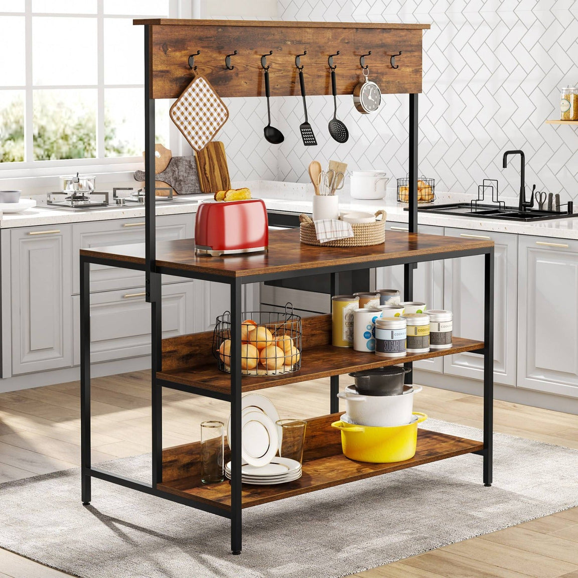 Brown-shelf kitchen rack with a black frame and raised wooden hook rail holding appliances, cookware and utensils.