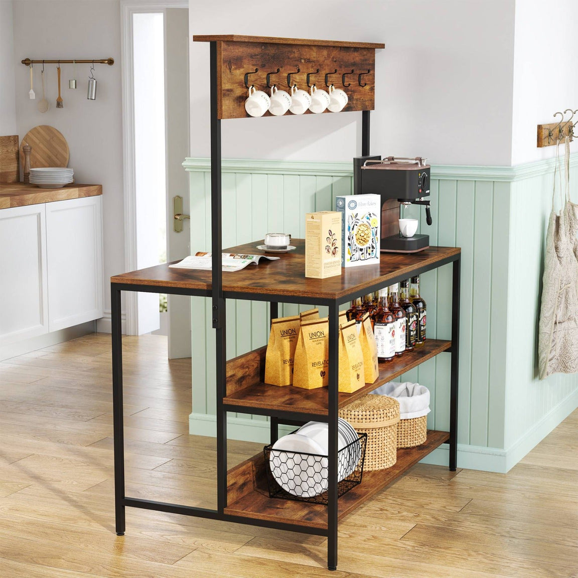 Brown-shelf kitchen rack with a black frame and raised wooden hook rail holding appliances, cookware and utensils.