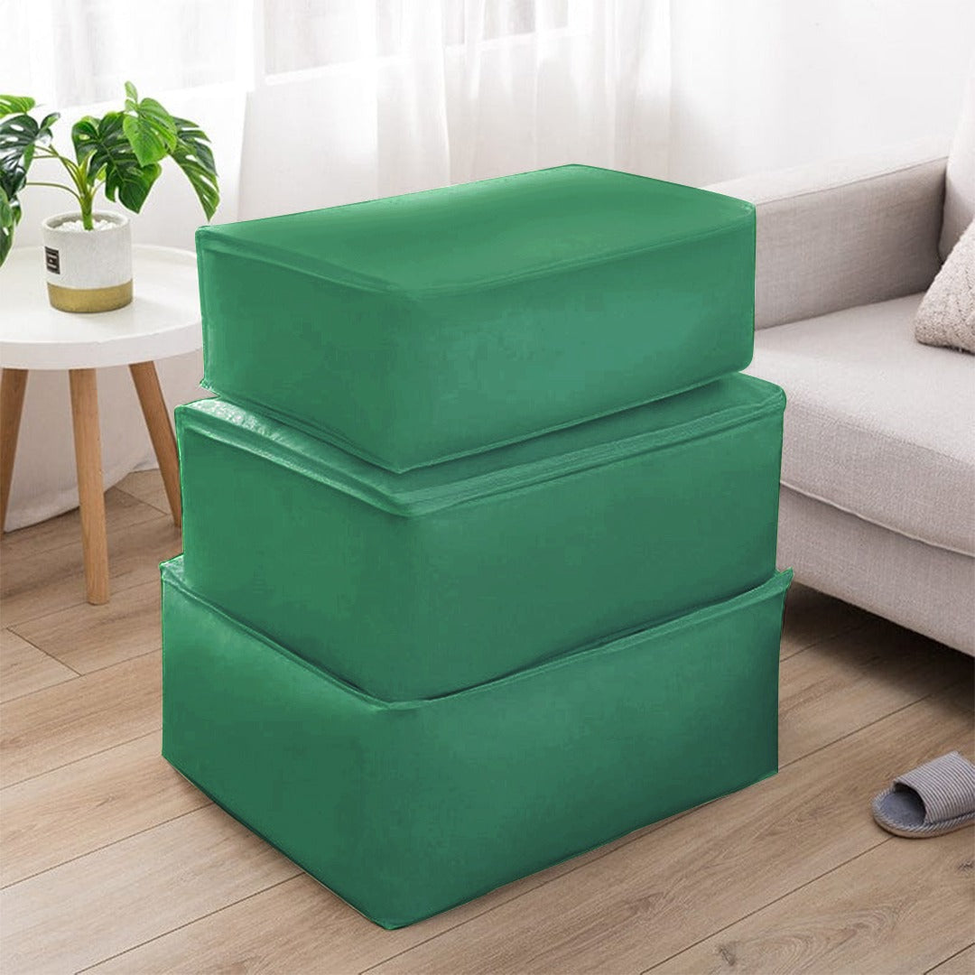 Three dark green fabric storage cubes stacked beside a sofa.