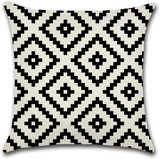 Cream cushion cover with repeating black stepped diamonds.