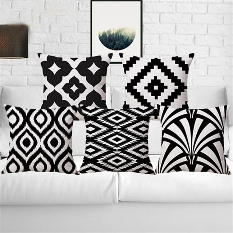 Black and white patterned cushion covers displayed on a white sofa.