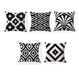 Five black and white cushion covers with diamonds and sweeping leaf-like patterns.