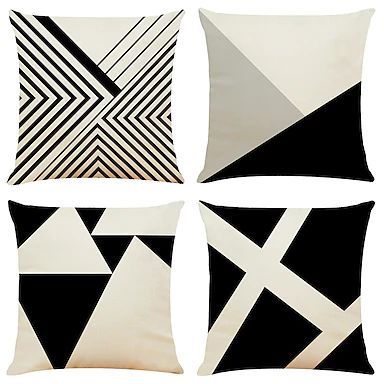 Four black, cream and grey cushion covers with geometric shapes and fine stripes.