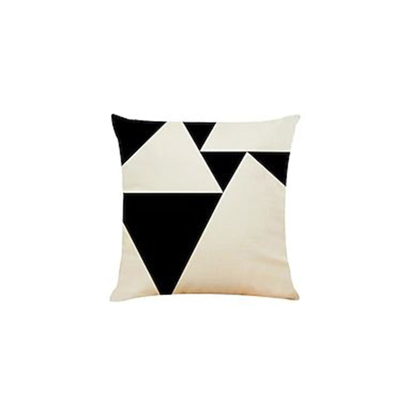 Cream cushion cover with assorted black triangular shapes.