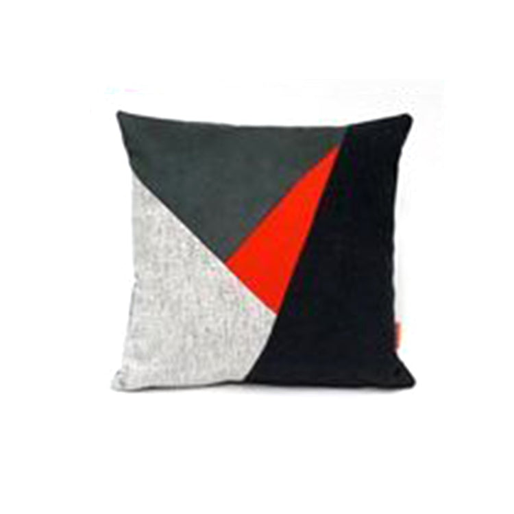 Cushion cover with grey, white, black and red triangular panels.
