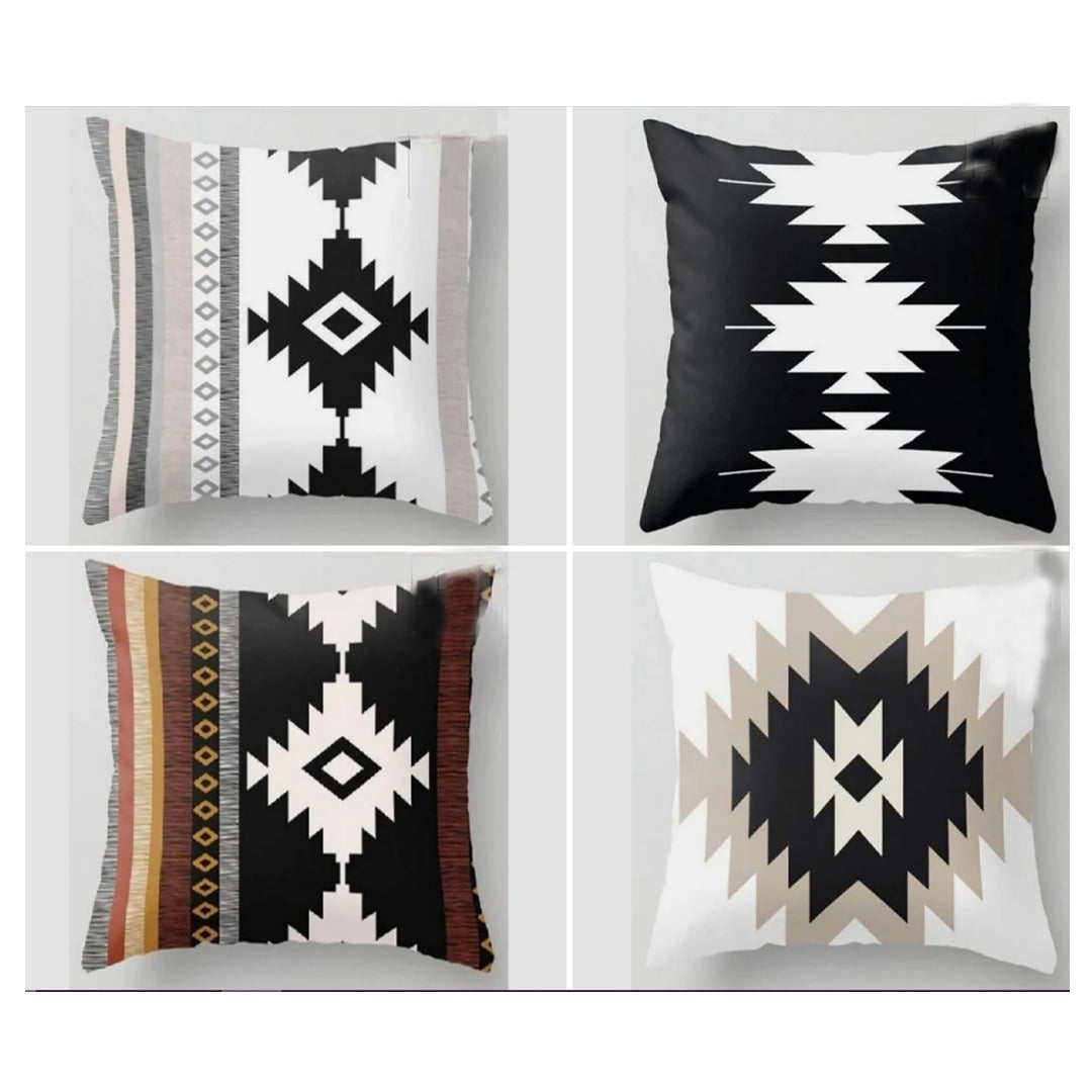 Four cushion covers with bold stepped diamond patterns in black, cream and earthy colours.