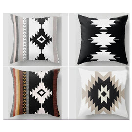 Four cushion covers with bold stepped diamond patterns in black, cream and earthy colours.