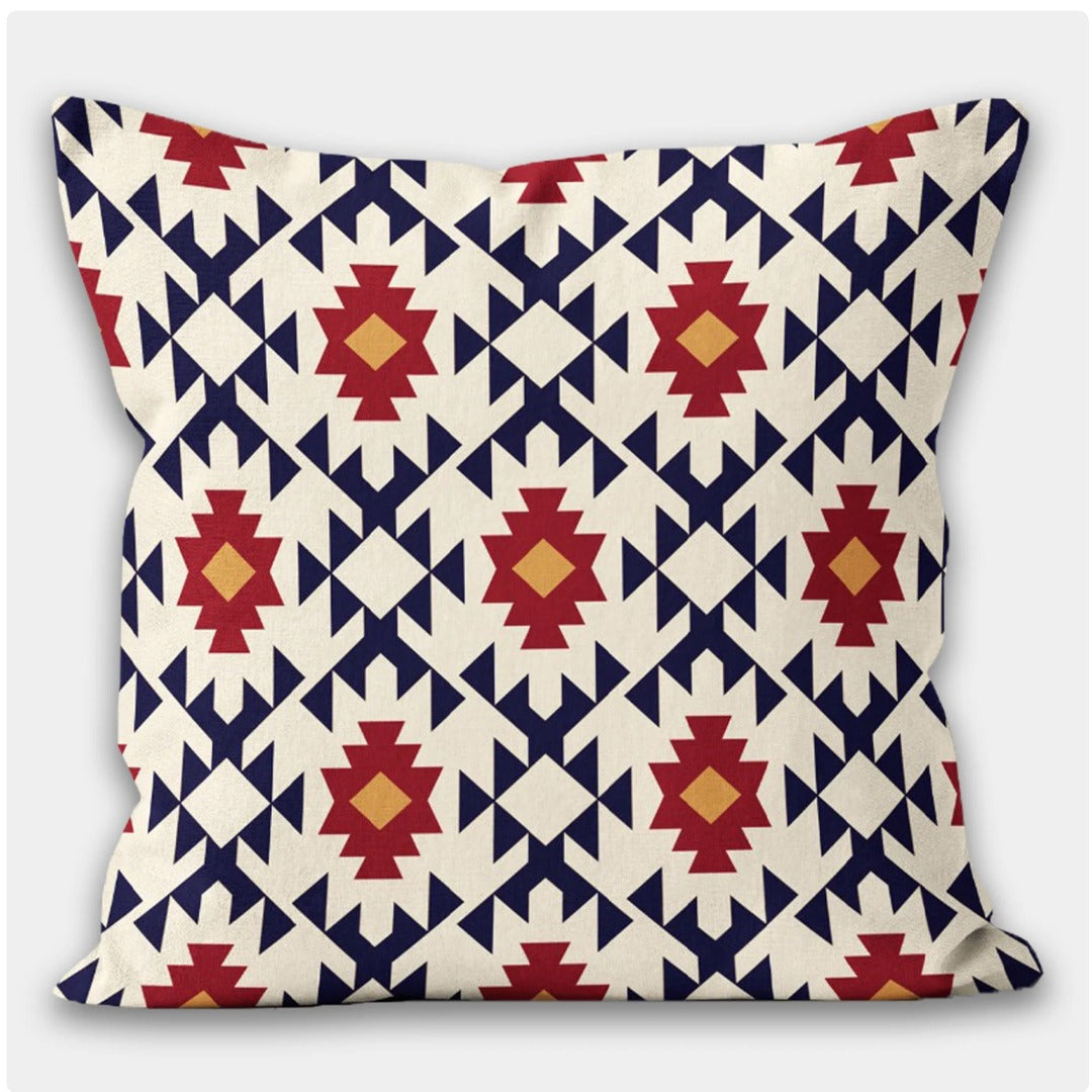Cream cushion cover with repeating navy, red and yellow geometric diamonds.