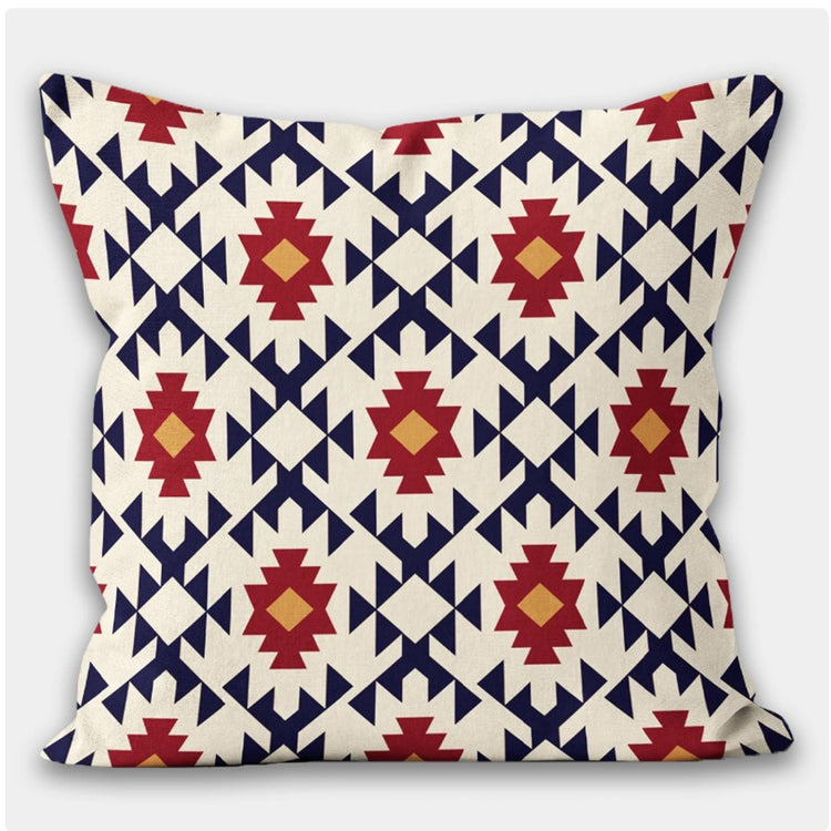Cream cushion cover with repeating navy, red and yellow geometric diamonds.