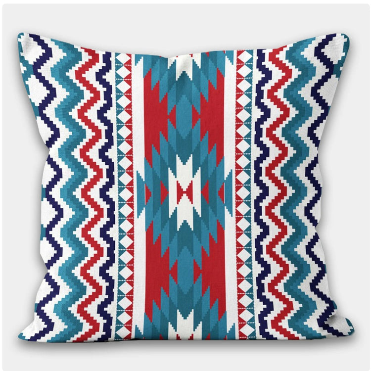 Cushion cover with vertical teal, navy, red and cream zigzag bands.