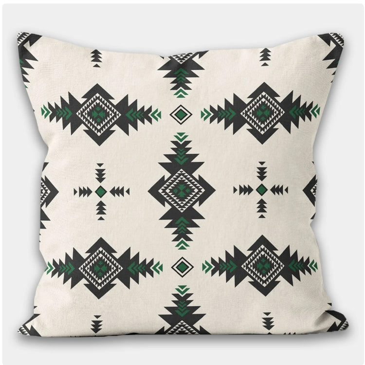 Cream cushion cover with dark green diamonds and small geometric motifs.