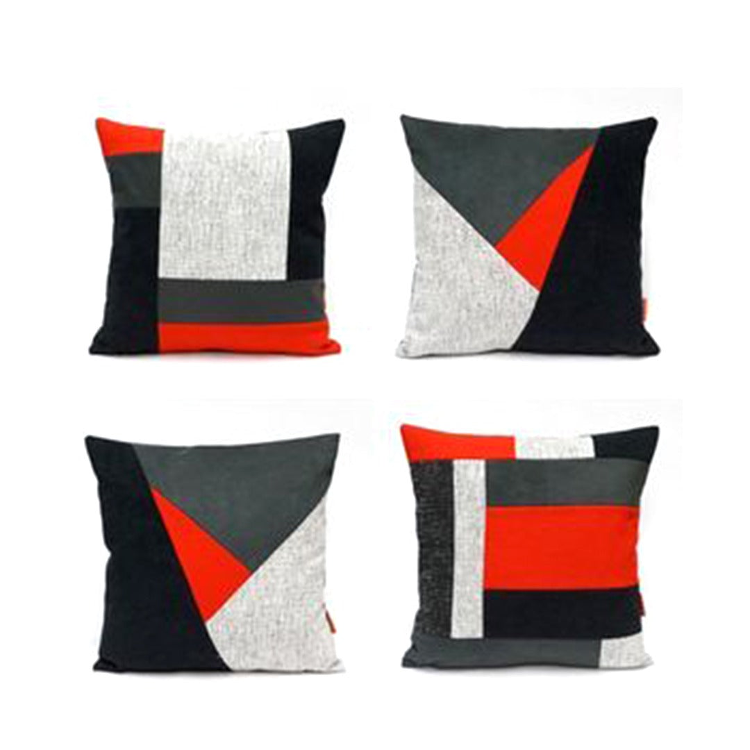 Four black, grey, white and red cushion covers with bold geometric panels.