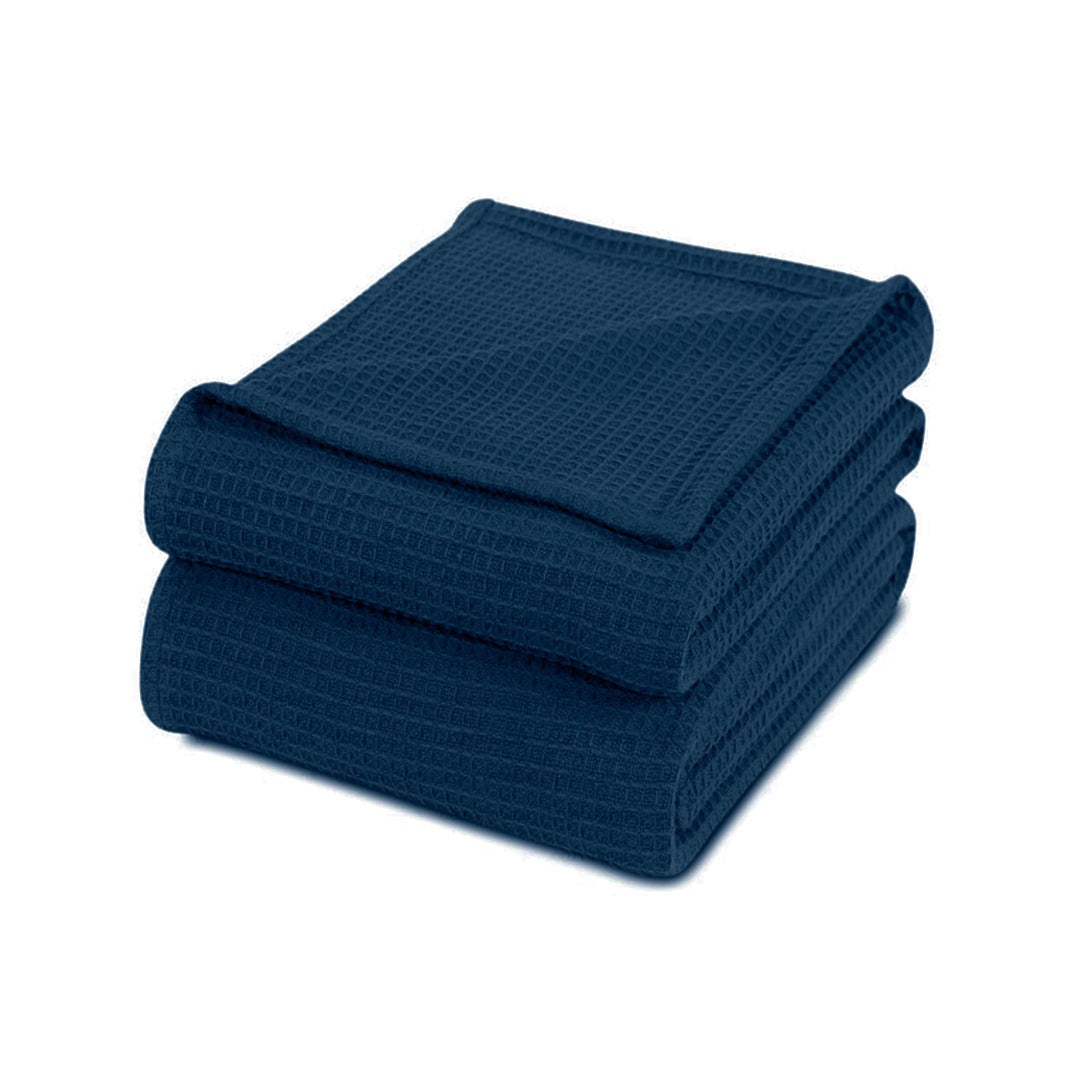 Folded navy blue waffle-weave cotton thermal blanket.