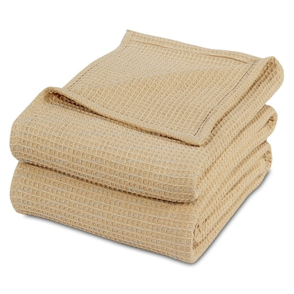 Folded beige waffle-weave cotton thermal blanket.