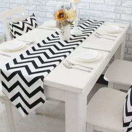 Black and white zigzag table runner on a white dining table.