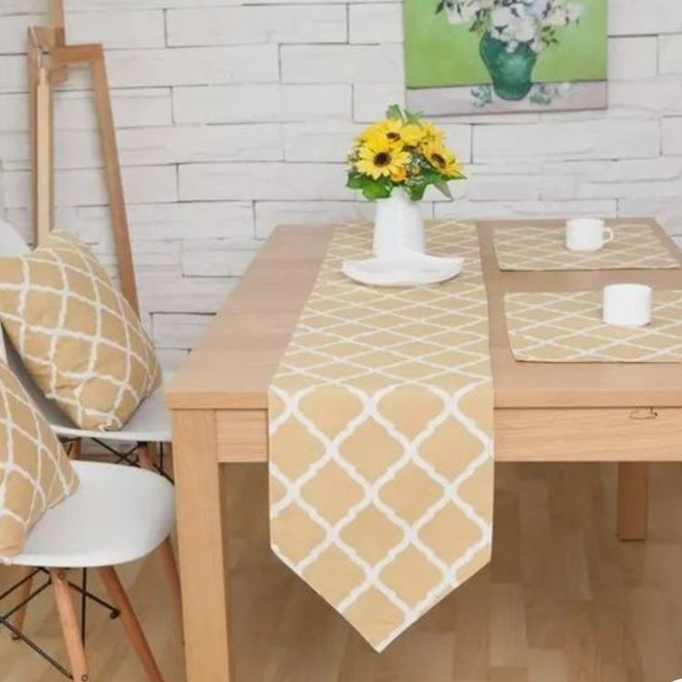 Beige table runner with a white diamond lattice pattern and matching placemats.