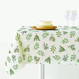 White tablecloth with small green botanical sprigs.