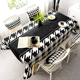 Black and white patterned dining tablecloth with a plain black centre.