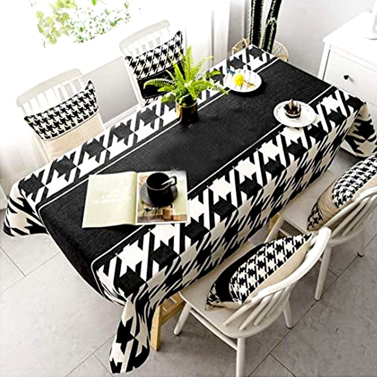 Black and white patterned dining tablecloth with a plain black centre.