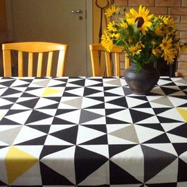 Black and white triangle-pattern tablecloth with yellow accents.