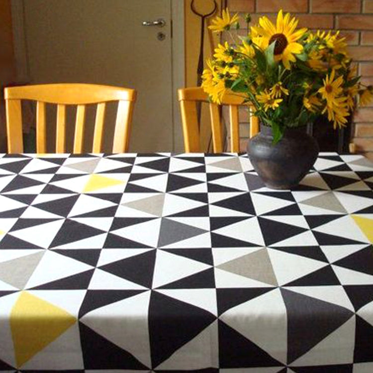 Black and white triangle-pattern tablecloth with yellow accents.